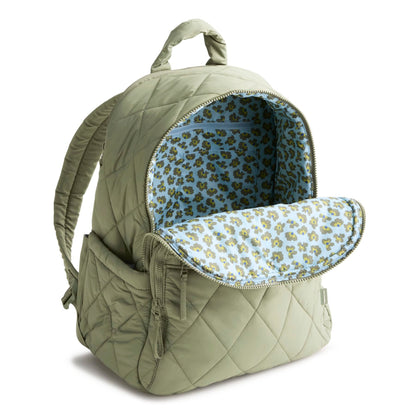 Green quilted backpack with floral interior on a white background
